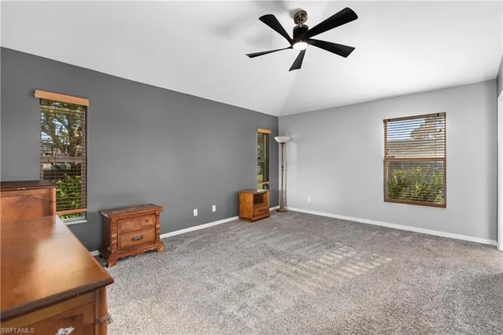 Unfurnished bedroom featuring light colored carpet and ceiling fan