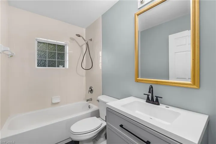 Bathroom with shower / tub combination and vanity