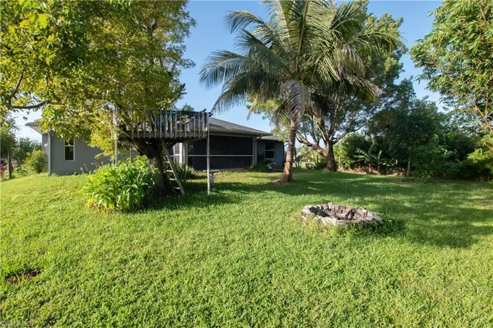 View of green lawn featuring a patio