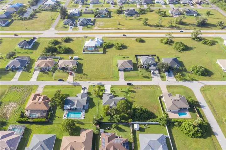 Aerial view of property's location with nearby suburban area