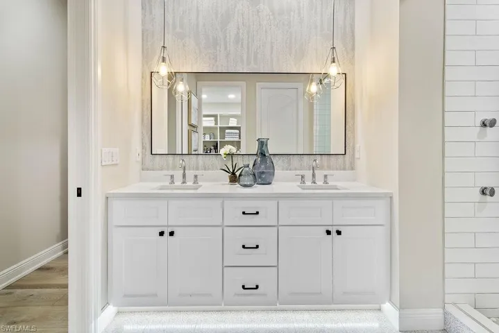 Master bathroom with custom wallpaper and plenty of storage