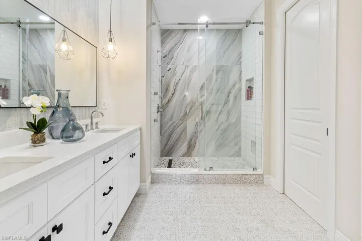 Custom tiled spa-like shower with multiple shower heads and body sprays