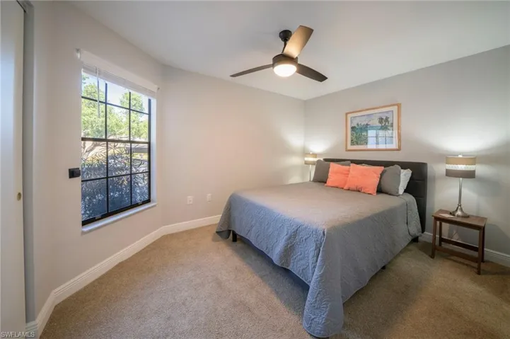 Carpeted bedroom with ceiling fan