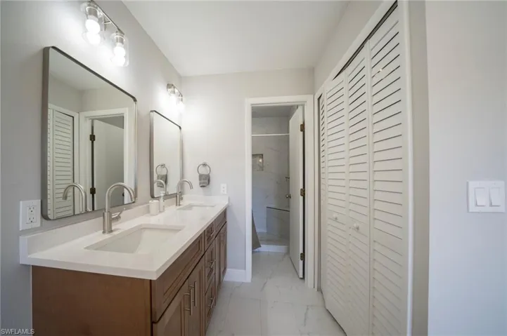 Bathroom with vanity and tiled shower