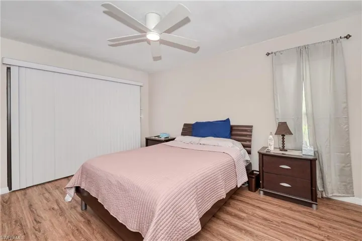 Bedroom featuring ceiling fan and light hardwood / wood-style flooring