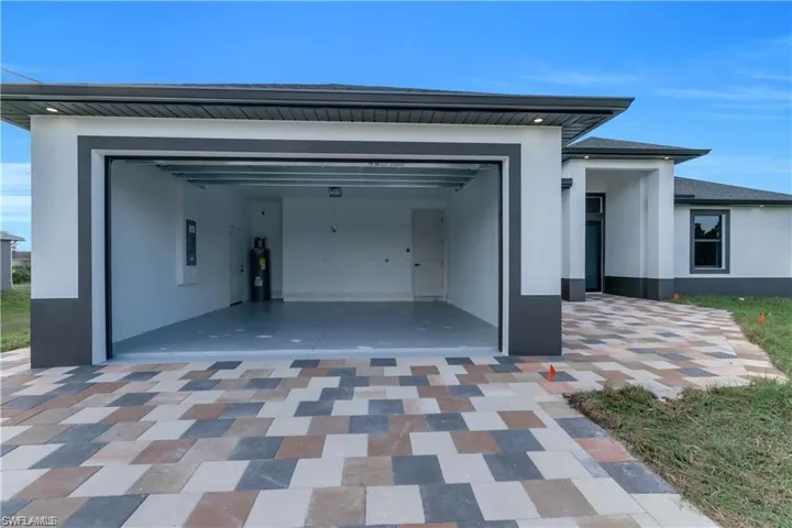 Garage with water heater and electric panel