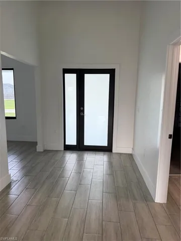 Spare room featuring wood finish floors and baseboards