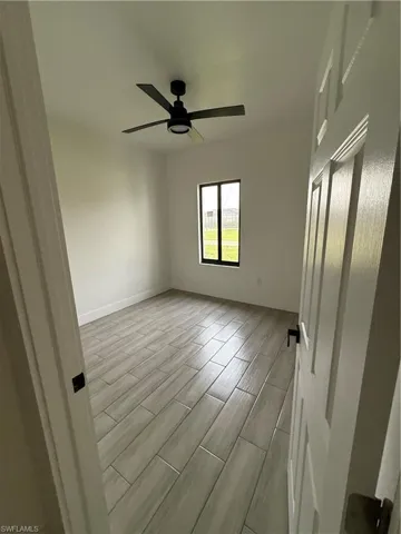 Empty room featuring wood finish floors and ceiling fan