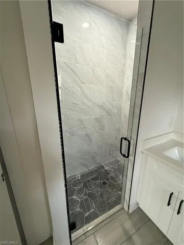 Bathroom with a stall shower and vanity