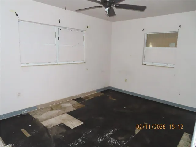 Spare room with a ceiling fan and baseboards