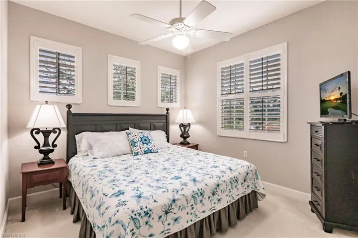 Bedroom with light colored carpet and ceiling fan