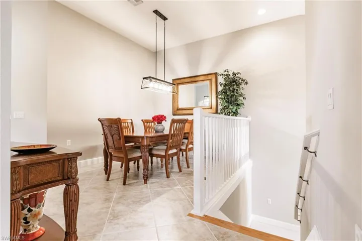 Dining area featuring light tile patterned floors and recessed lighting