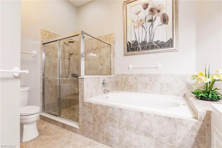 Full bathroom with a bath, a stall shower, and tile patterned floors