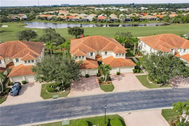 Aerial view of residential area with a large body of water and a local golf course