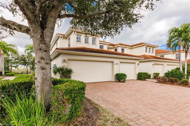 Mediterranean / spanish-style home with decorative driveway, a garage, stucco siding, and a tile roof