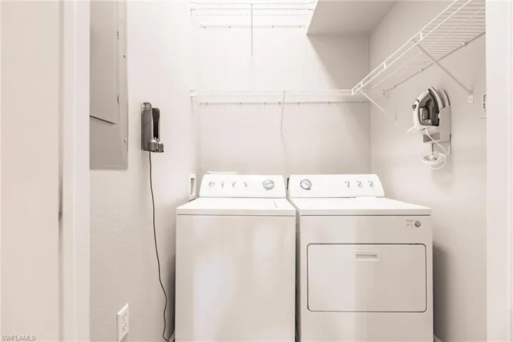 Laundry room featuring washer and dryer and electric panel