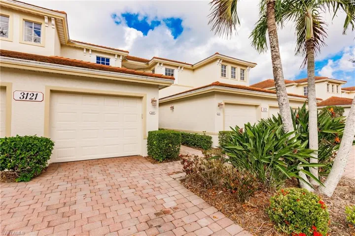 Mediterranean / spanish-style house featuring stucco siding, a tile roof, and a garage