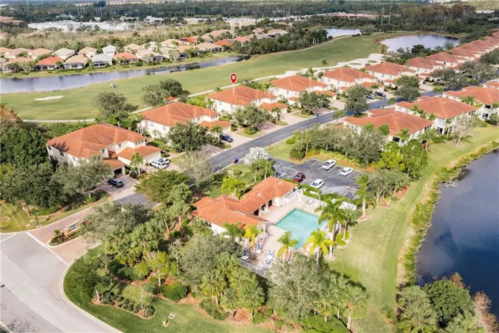 Aerial perspective of suburban area featuring a large body of water