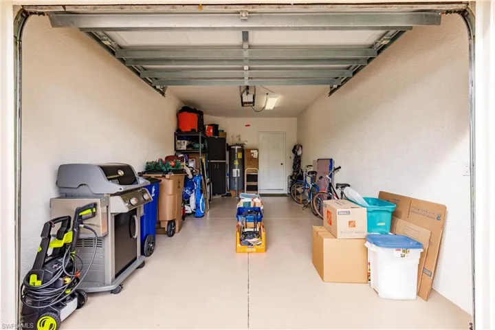 Garage with a textured wall and water heater