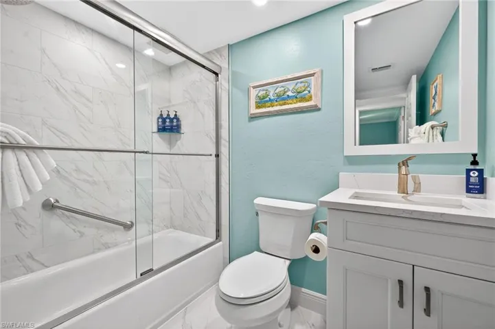 Full bath featuring vanity and enclosed tub / shower combo