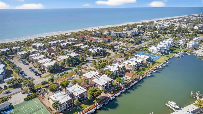 Aerial view of residential area with waterfront with a beach