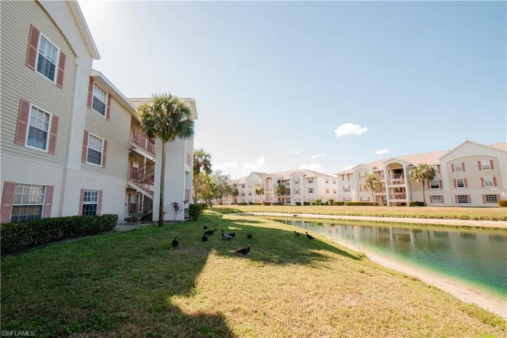 Surrounding community featuring a lawn and a water view