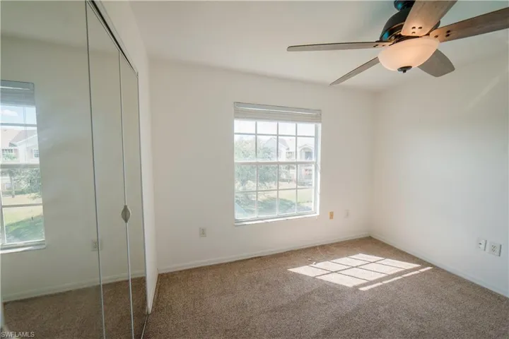 Unfurnished bedroom with a closet, carpet flooring, and ceiling fan