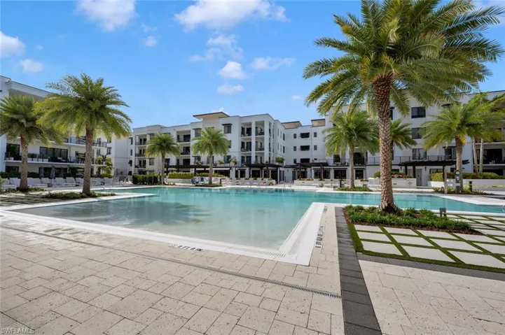 Expansive pool deck with spa and multiple areas for relaxation.