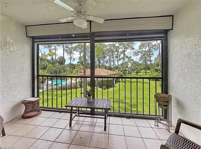 Sunroom / solarium with view of wooded area