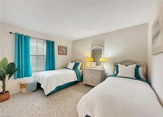 Bedroom featuring a textured ceiling and carpet floors