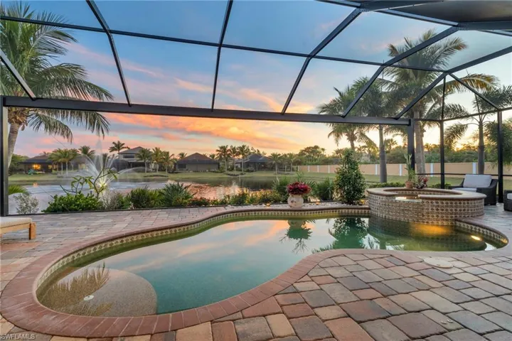 Pool at dusk with an in ground hot tub