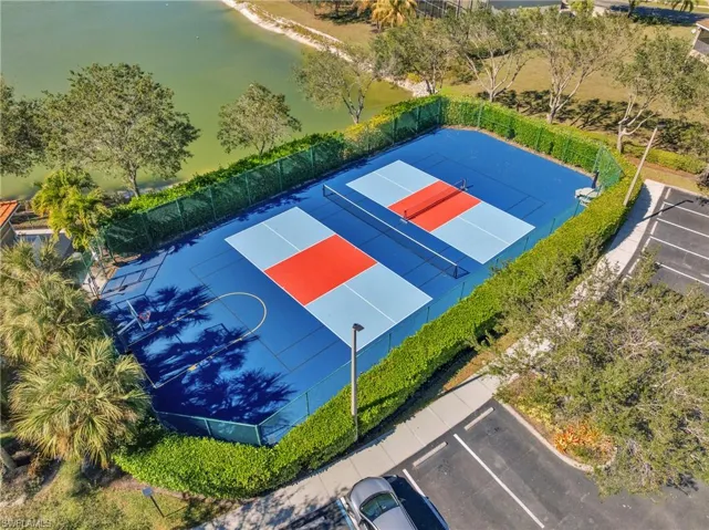 View of sport court with a water view