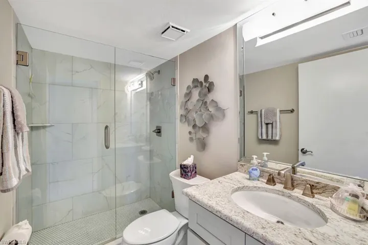 Tiled bedroom featuring ceiling fan