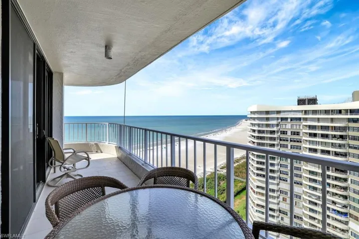 Balcony with a view of the beach and a water view