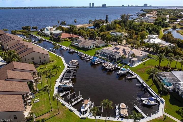 Aerial view of residential area featuring a nearby body of water