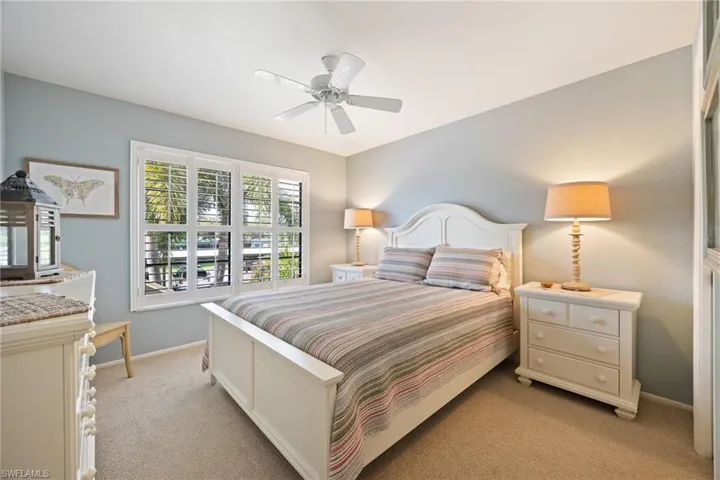 Bedroom featuring ceiling fan and light carpet