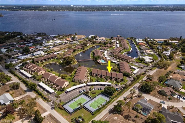 Aerial perspective of suburban area with a nearby body of water