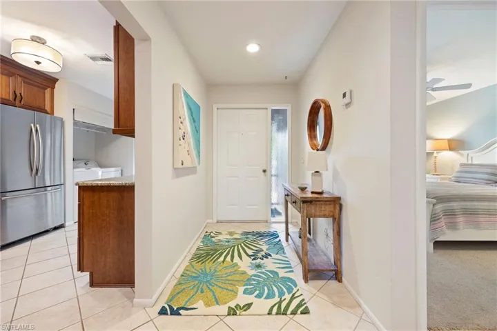 Entrance foyer featuring light tile patterned floors, recessed lighting, and separate washer and dryer