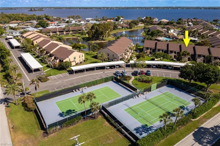 Aerial perspective of suburban area featuring a nearby body of water
