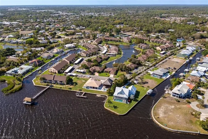 Aerial view of property's location with nearby suburban area and a nearby body of water