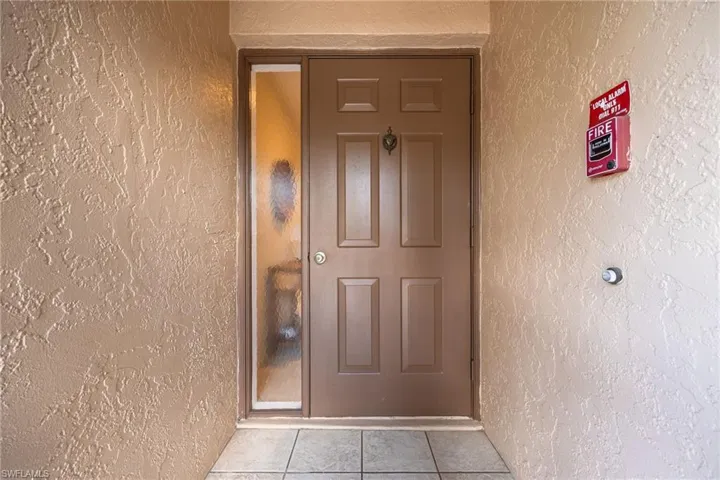 Entrance to property featuring stucco siding