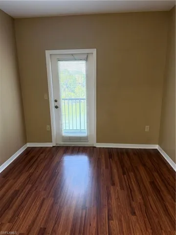 Spare room featuring dark wood-type flooring
