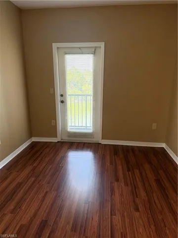 Unfurnished room with dark wood-style floors