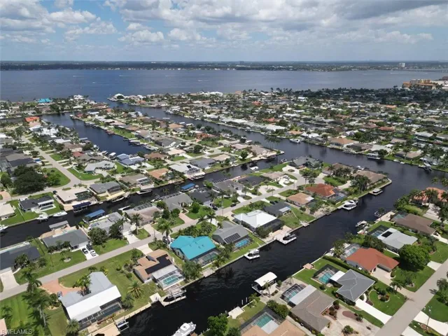 Aerial overview of property's location featuring nearby suburban area and a large body of water