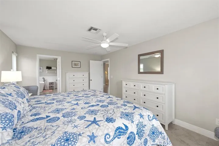 Bedroom with light marble finish flooring and ceiling fan