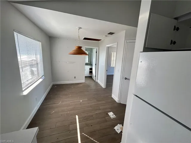 Unfurnished dining area with wood-type flooring