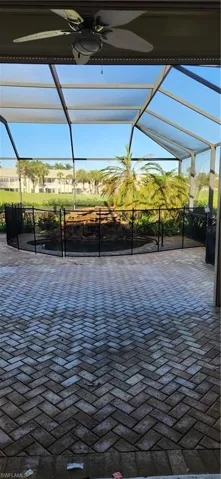 View of patio / terrace featuring a ceiling fan and glass enclosure