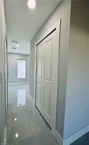 Hallway featuring recessed lighting and marble finish floors