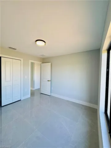 Unfurnished bedroom with baseboards and a closet