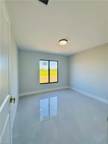 Unfurnished room featuring baseboards